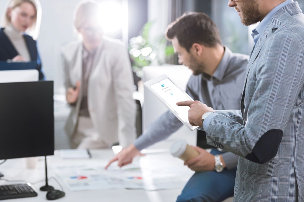 Image of a man in a business meeting, featuring SEO & Reputation Management and highlighting custom logo solutions tailored for every business.