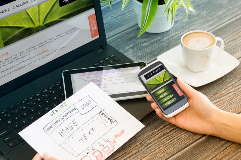 What We Offer Image of a hand holding a smartphone, featuring SEO & Reputation Management and highlighting the range of digital marketing services offered.